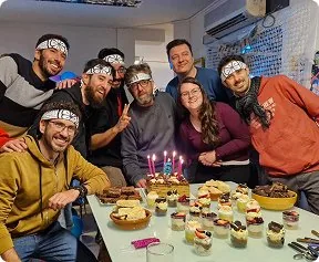 Odaclick team celebrating a birthday with a cake, wearing headbands